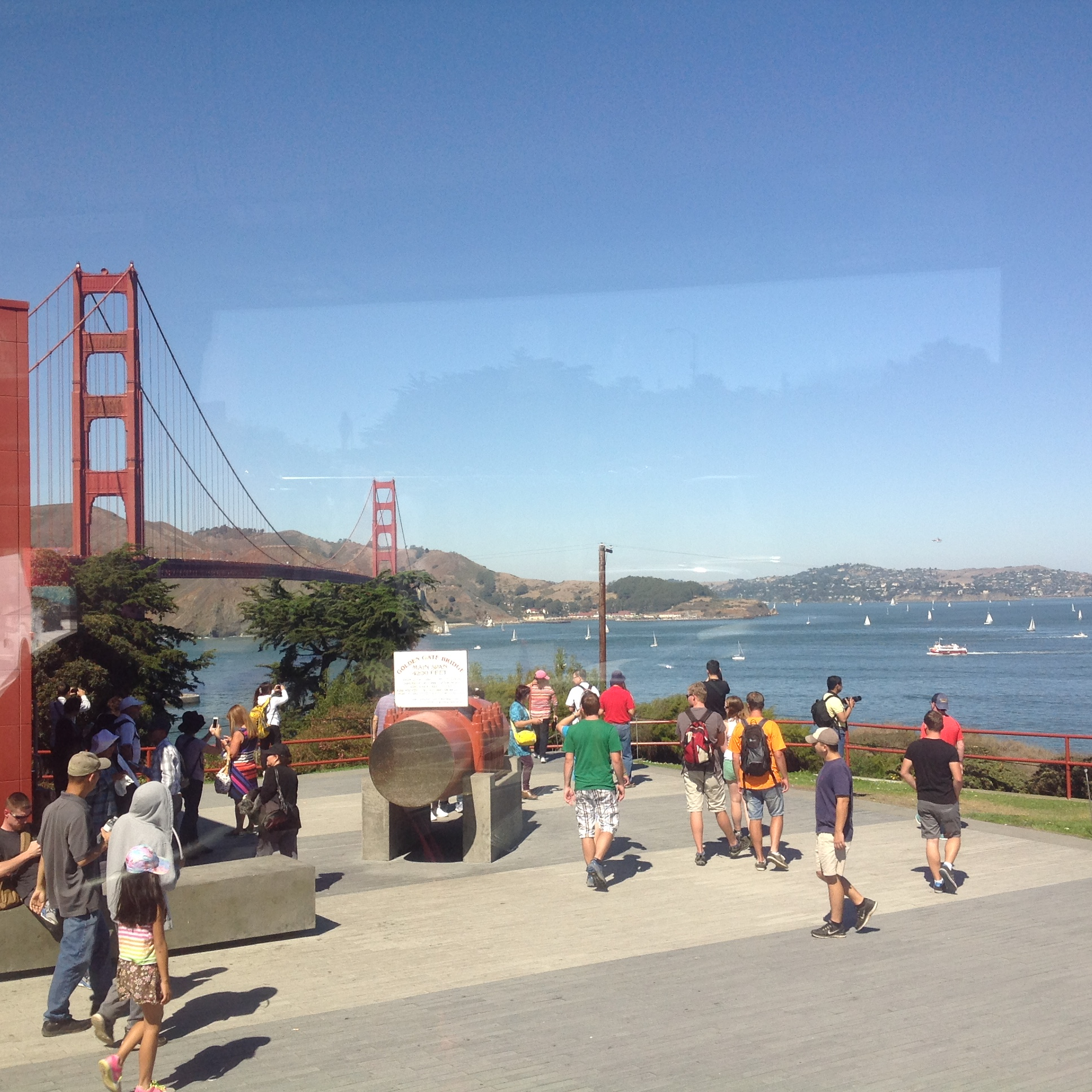 Crowded area with the Golden Gate Bridge in the background.