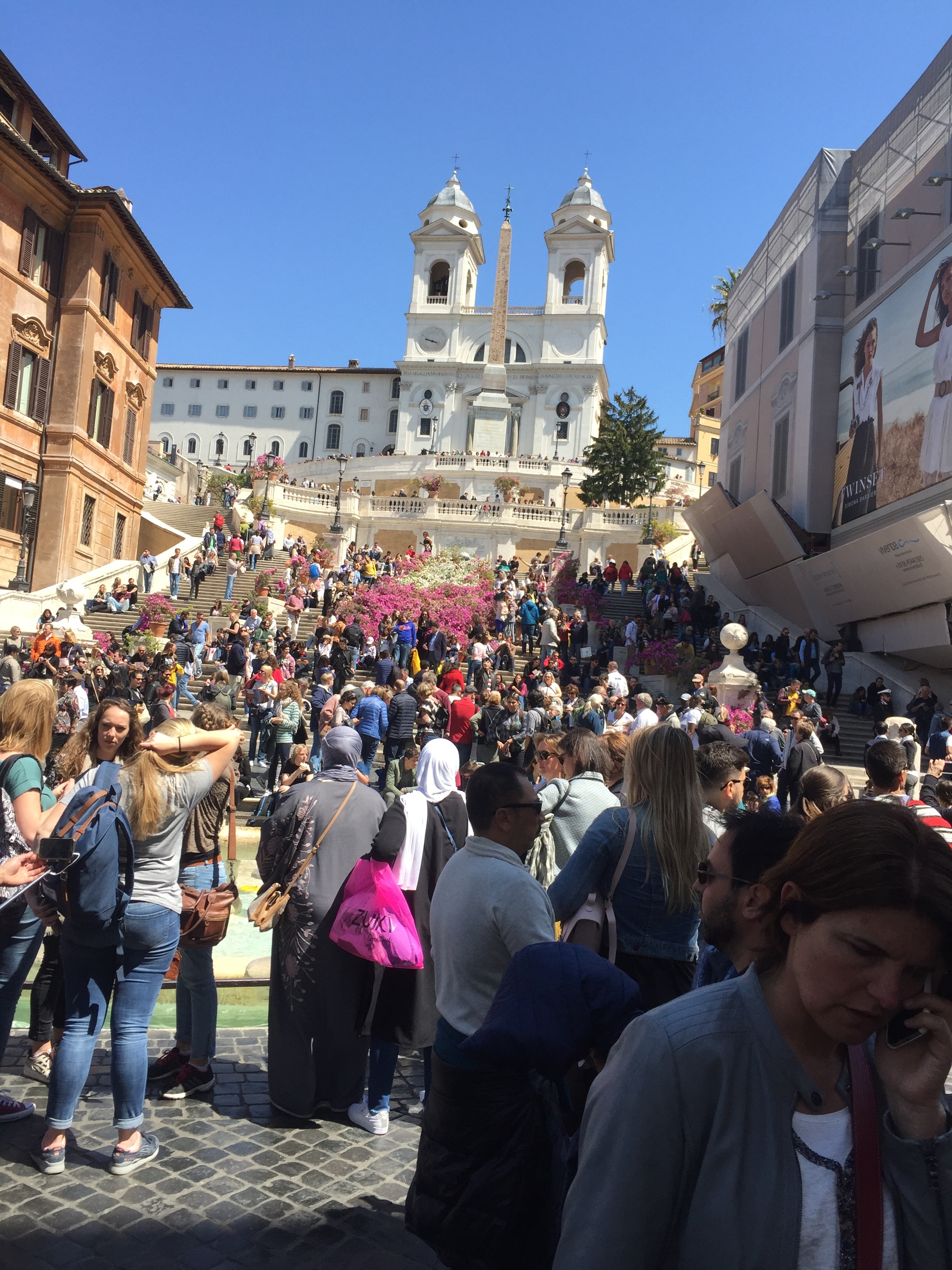 Crowded Spanish Steps with flowers in Rome.