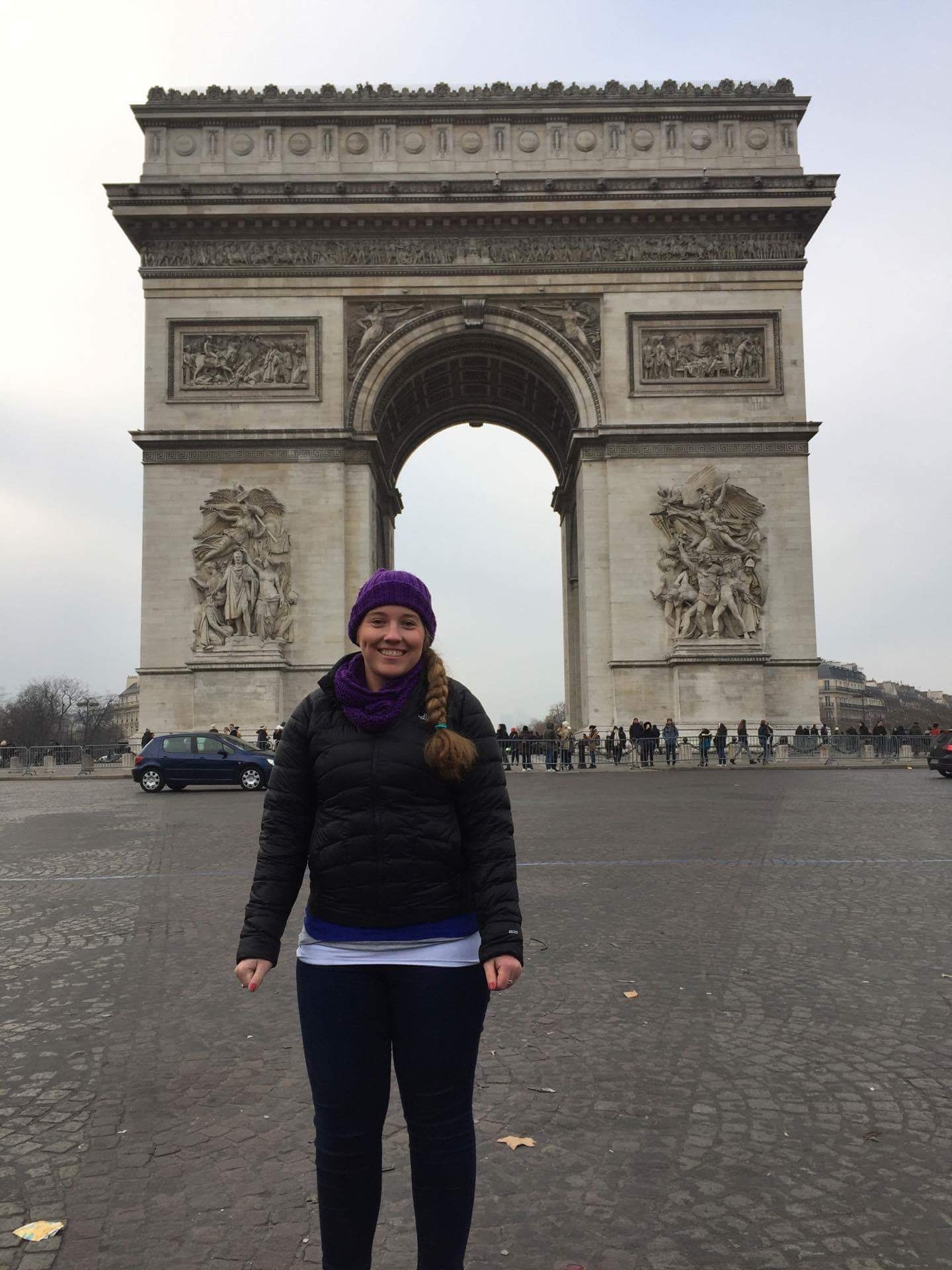 Person standing in front of the Arc de Triomphe.