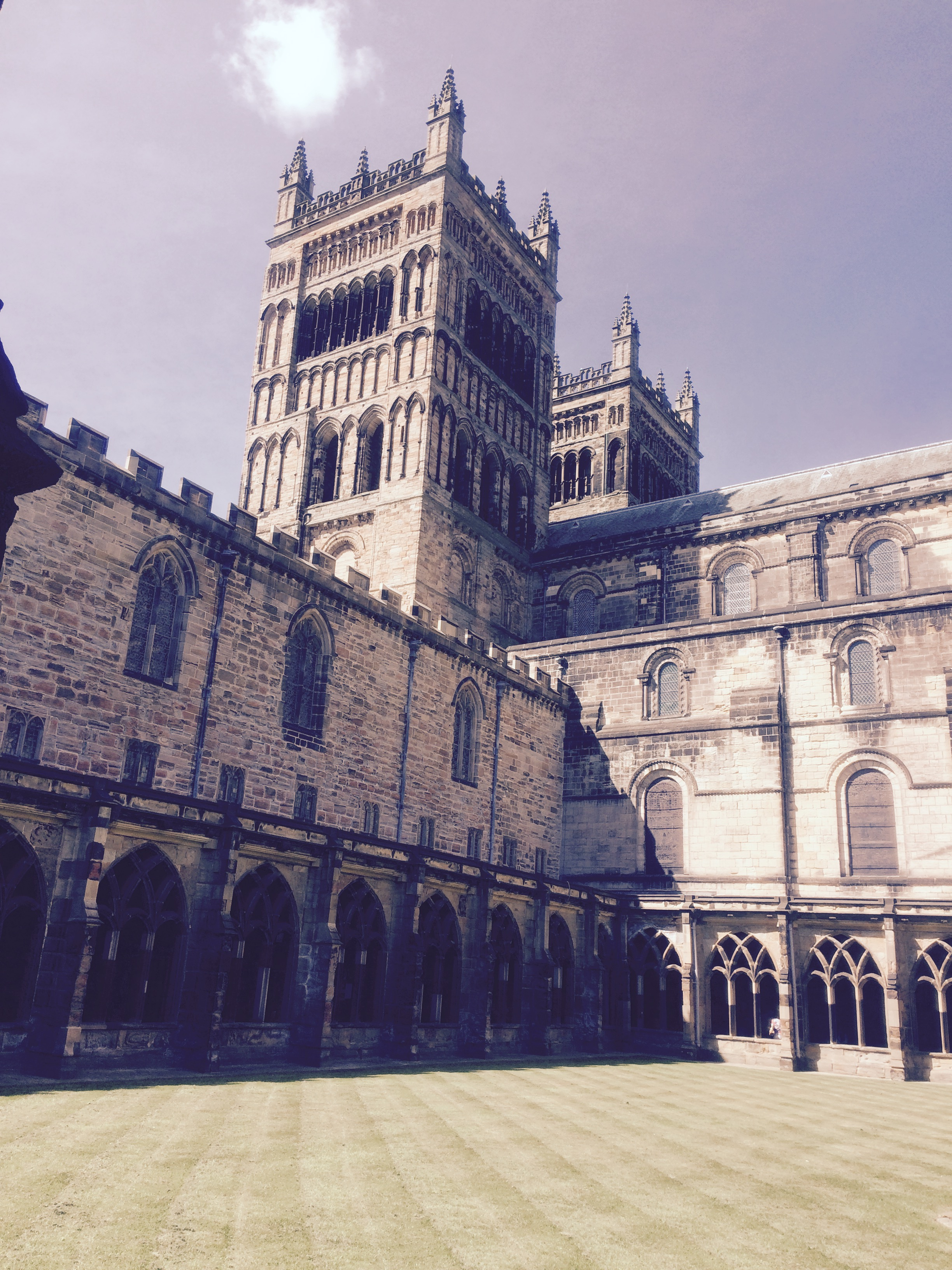 Historical stone building with arched windows and towers.
