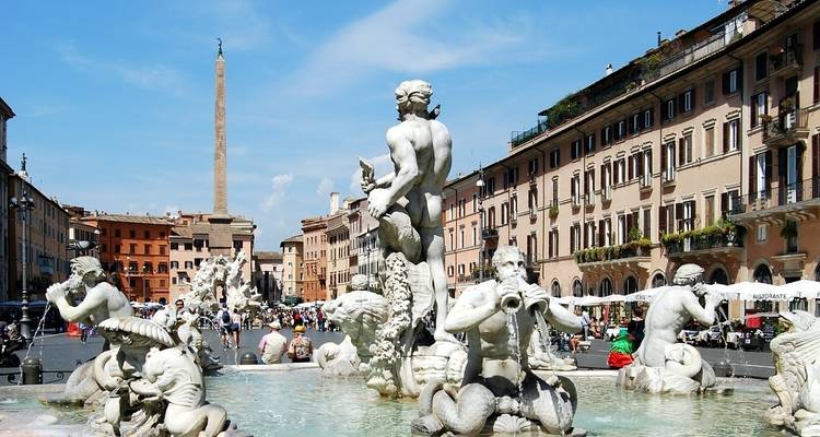 Baroque statues of Fontana dei Quattro Fiumi framed by historic buildings in Piazza Navona.