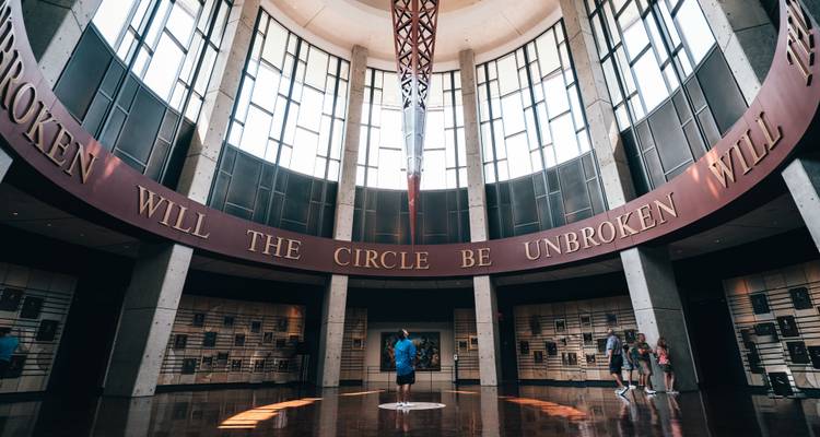 Modern rotunda interior with high windows and the phrase 'Will The Circle Be Unbroken' encircling visitors