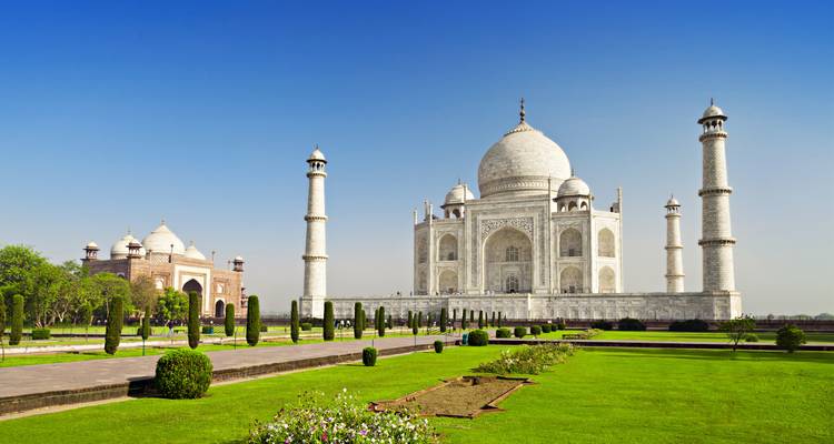 Taj Mahal with clear blue sky and gardens in front.