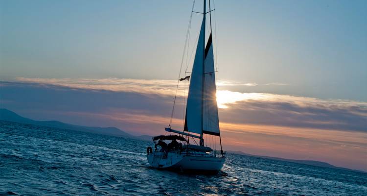 Sailboat on the sea at sunset.