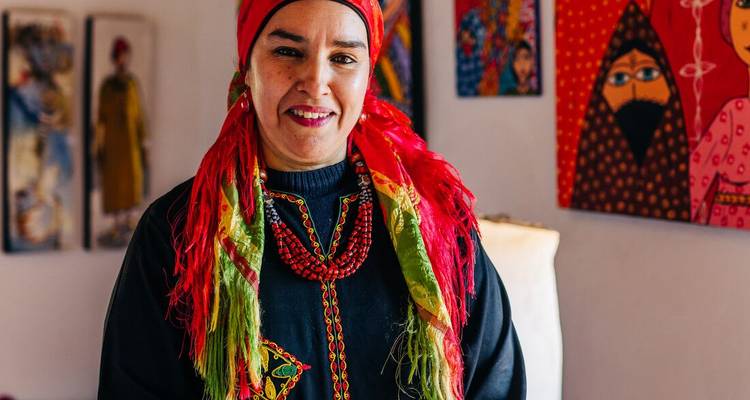 Portrait of a smiling woman in traditional attire.