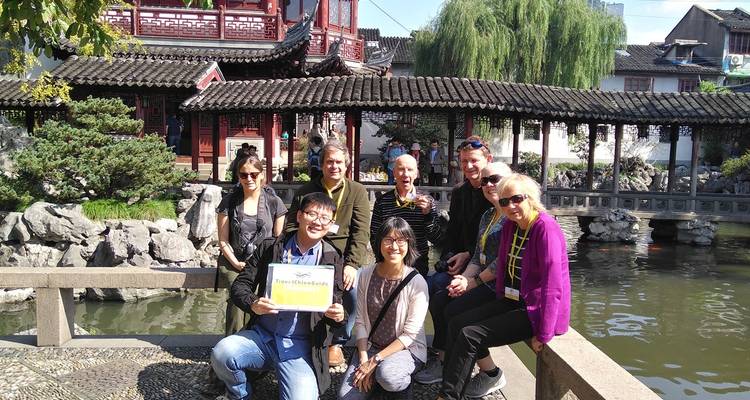 Group of people at a traditional Chinese garden.