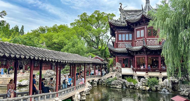 Picturesque traditional building with a pond and bridge.
