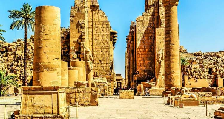 Luxor-Tempel-Ruinen mit Touristen und blauem Himmel.