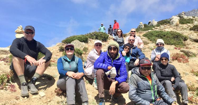 Group of trekkers sitting together, looking at the camera.