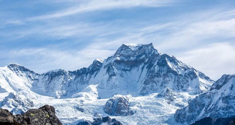 Snowy mountain range under a clear sky.
