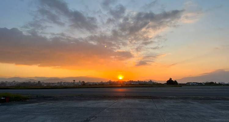 Serene zonsondergang over verre stadsskyline gezien vanaf het luchthaventerrein