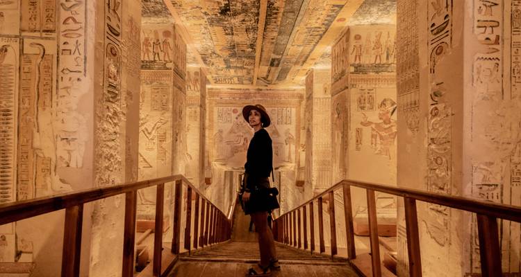 Vrouw in een oude Egyptische tombe die de hiërogliefen bewondert.