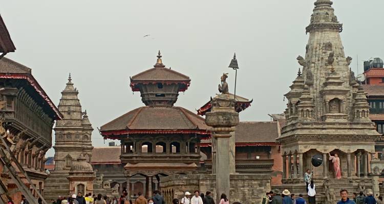 Historic pagoda-style temples tower over a busy square filled with locals and visitors.