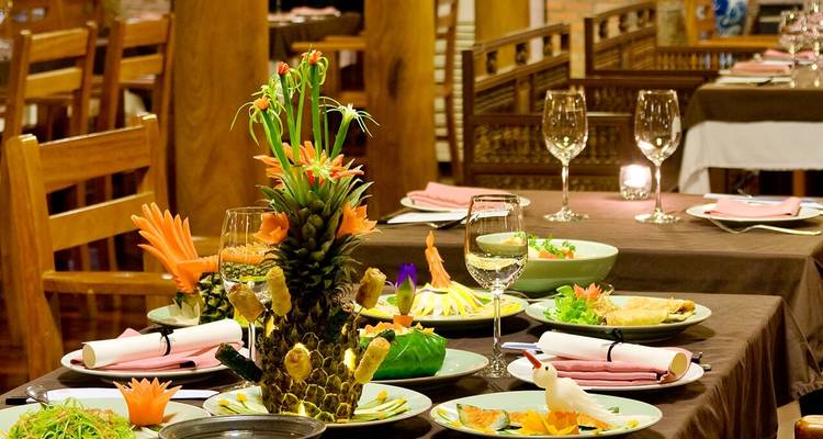 Fine dining setting with intricately arranged dishes and decorations.