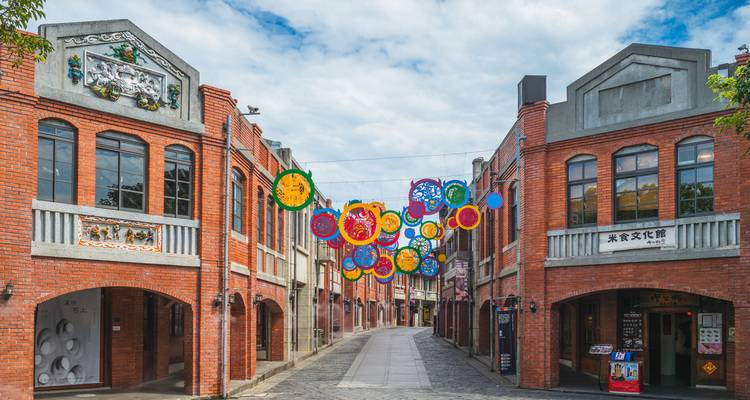 Colorful street with circular decorations in a historic district.