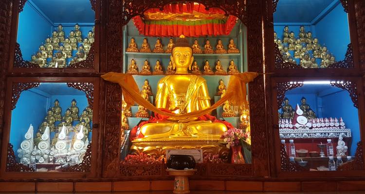 An intricately decorated Buddhist shrine with golden statues.