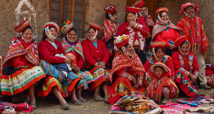 A group of people in traditional Peruvian clothing posing for a photo.