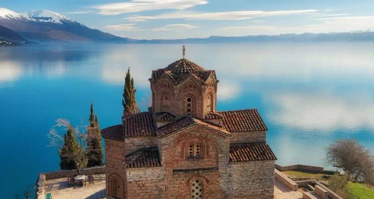 Medieval Church of St. John at Kaneo perched above the glassy blue waters of Lake Ohrid