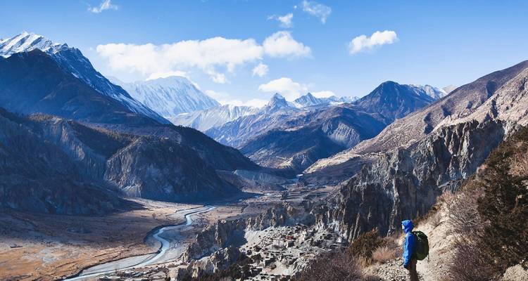 Hiker overlooking a vast mountainous landscape in Annapurna.