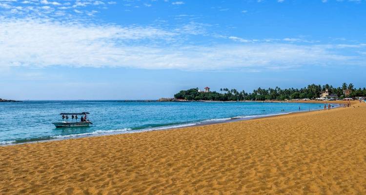 Beautiful beach with golden sand and clear blue waters.