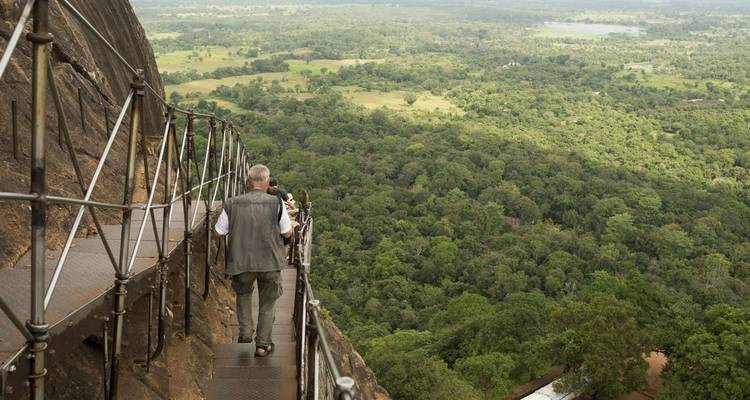 Tourist walking up a mountain with scenic view.