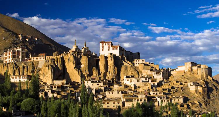 Monastery on a rocky hillside with clear skies.