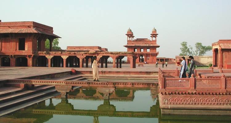 Historic complex with people walking through.