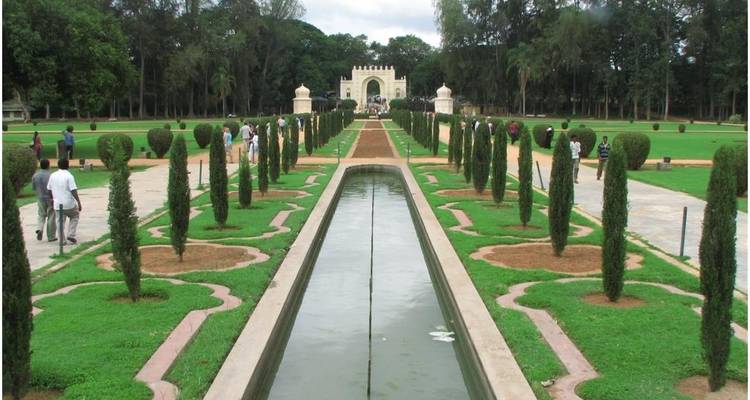 Symmetrical garden pathway leading to a historical building.