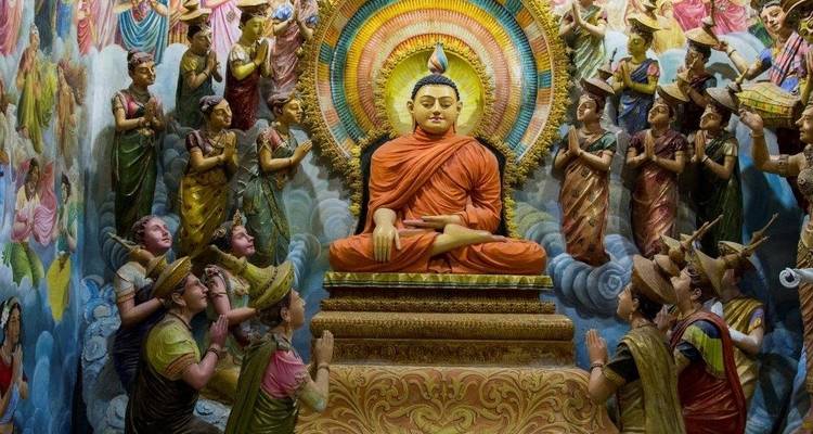 Vibrant and detailed religious sculpture scene depicting Buddha surrounded by followers.