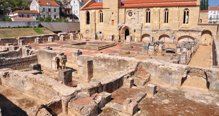 Ancient ruins and an old church with yellowed stones.