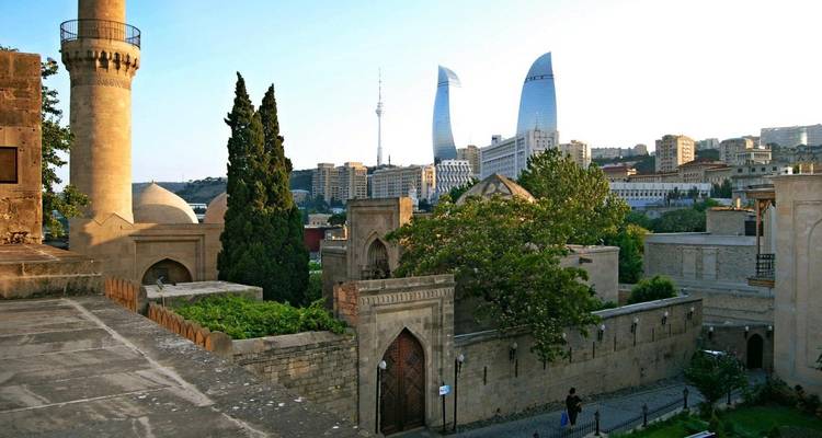 View of ancient architecture with modern city skyline.