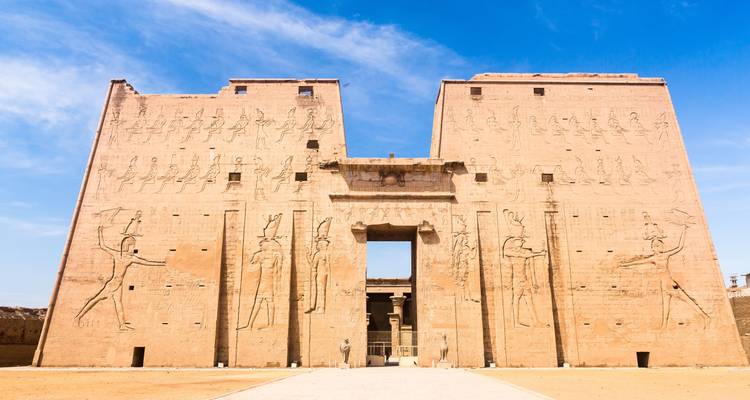 Facade of an ancient Egyptian temple with carved figures.