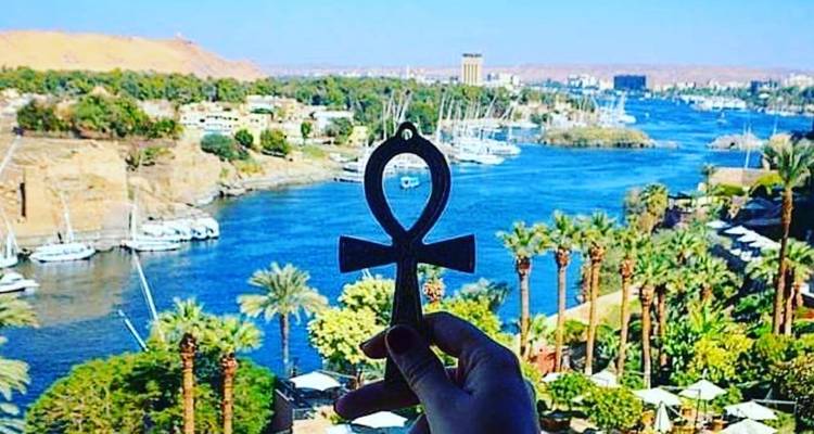 View of the Nile River with a hand holding an ankh.