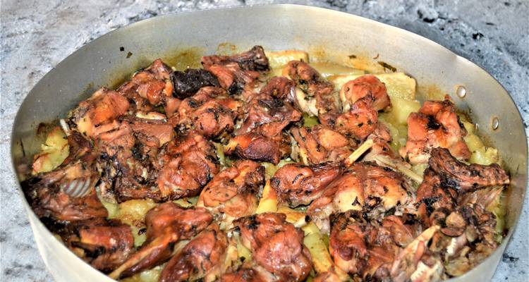 Une casserole de lapin rôti aux pommes de terre.