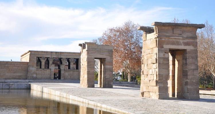 Ancient Egyptian-style temple with columns reflected in a water body.