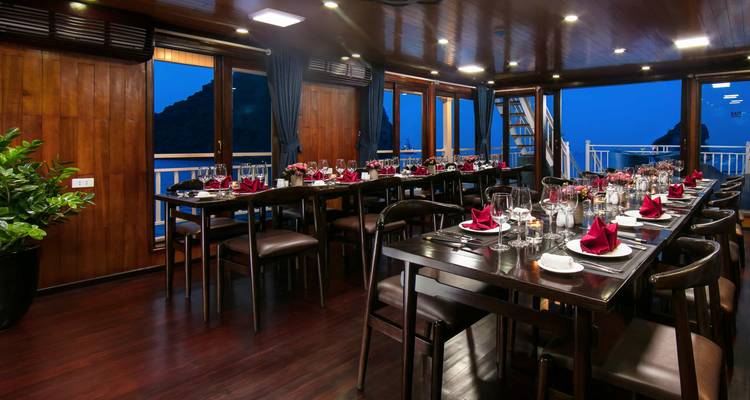 Elegant dining room on a cruise ship set for dinner.