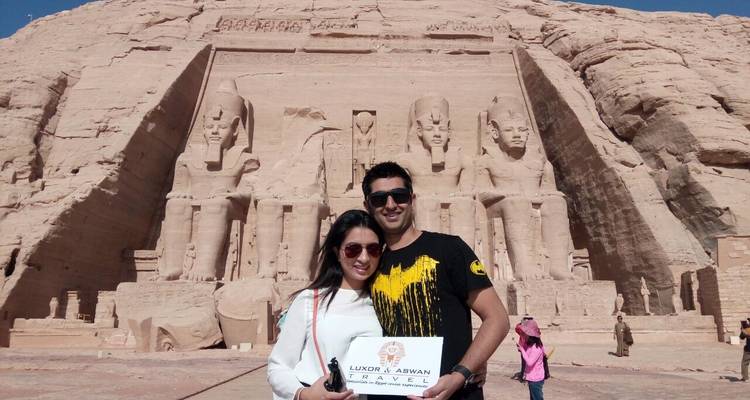 Couple with a travel sign in front of Abu Simbel Temple.