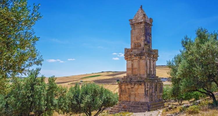 Mausoleo de la época romana en un campo con olivos.