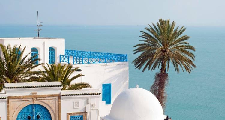 Arquitectura tradicional blanca y azul con vistas al mar.