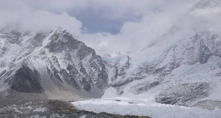 Cloud-shrouded Himalayan giants rising above the Khumbu glacier and Everest Base Camp tents