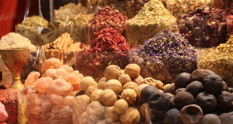 Variety of colorful spices displayed in a market.
