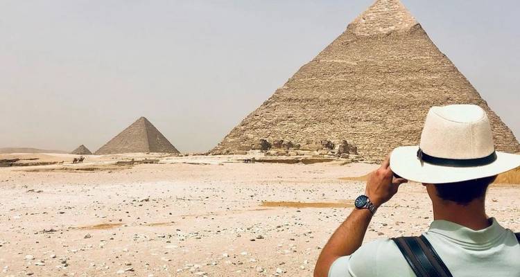 Person photographing the pyramids.