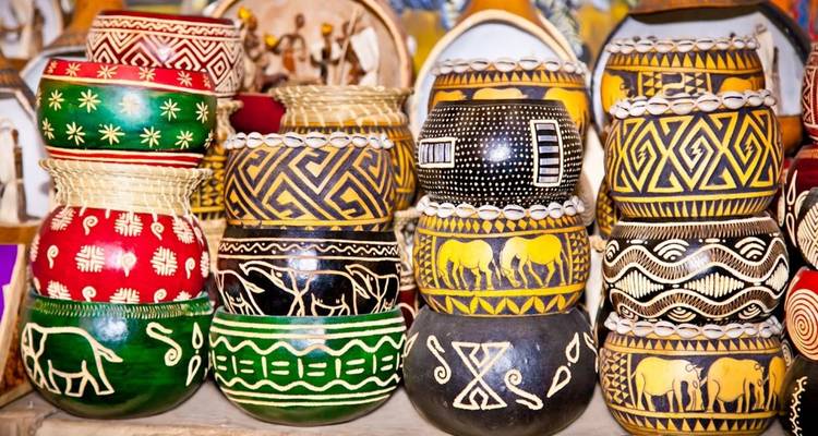 Array of colorful pottery with traditional patterns on display.