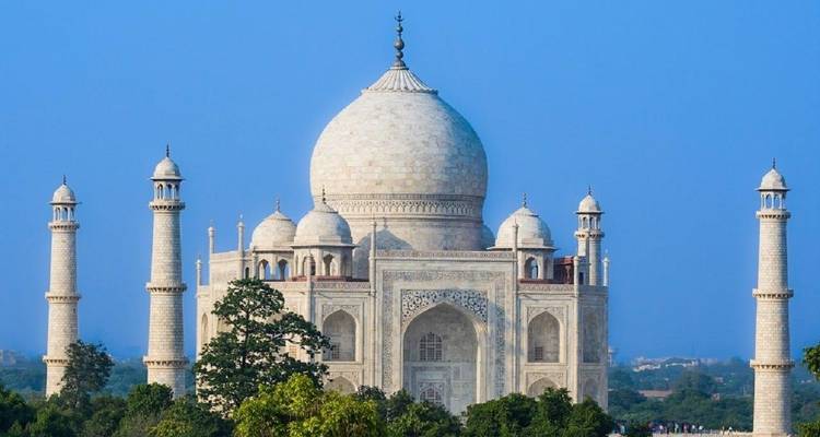 Iconic view of the Taj Mahal with clear blue sky background.