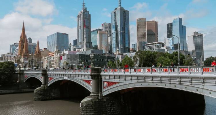 Melbourne city skyline with Princes Bridge spanning the Yarra River on a bright day.