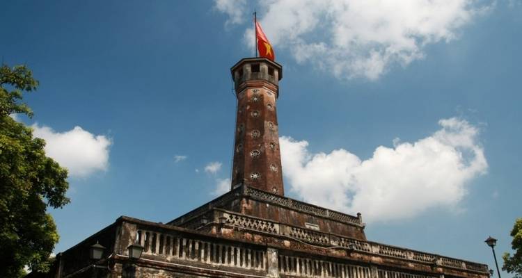 Historic tower structure with a flag on top.