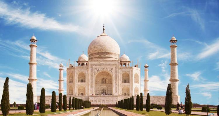 Taj Mahal with a clear blue sky and reflecting pool.
