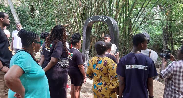 Group listening to a guide by a historical bath site.