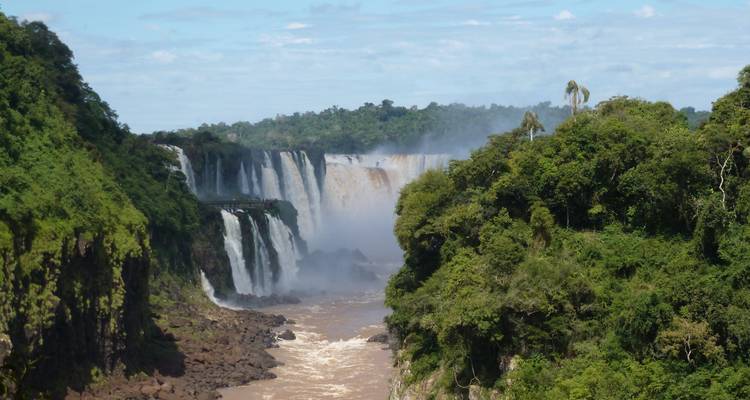 Lush tropical scenery with water cascading down Iguazu Falls.