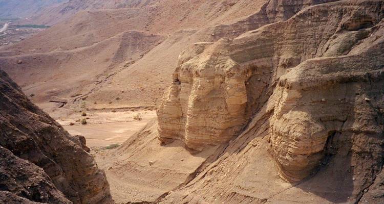 Barren desert landscape with eroded rock formations.